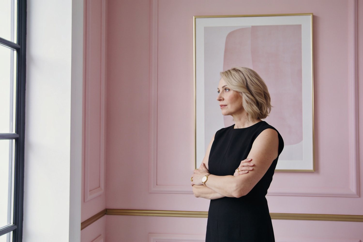 A poised clinic owner in a calm, light-filled studio
